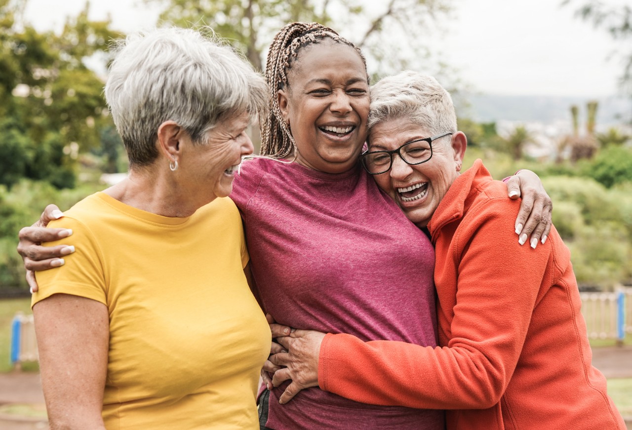 Three friends hugging and laughing