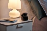 Ampli Energy R AX on a bedside table next to the bed