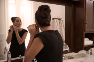 A senior woman getting ready before going out